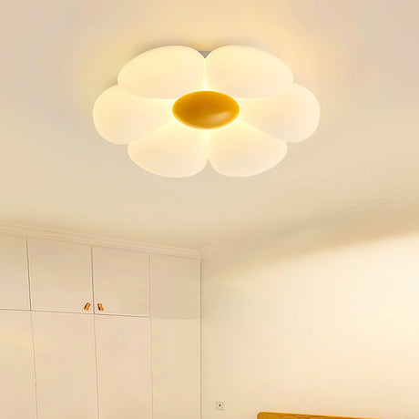 Flower ceiling light with a yellow center lit in a pale bedroom