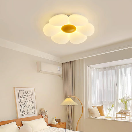 Flower ceiling light with a yellow center in a bedroom with a floor lamp