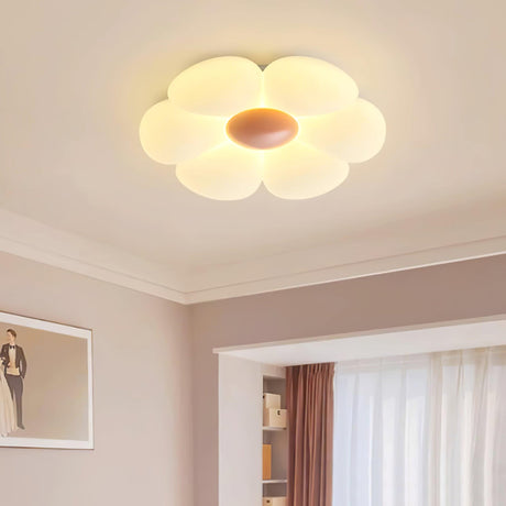 Flower ceiling light with a pink center in a room with a pink wall