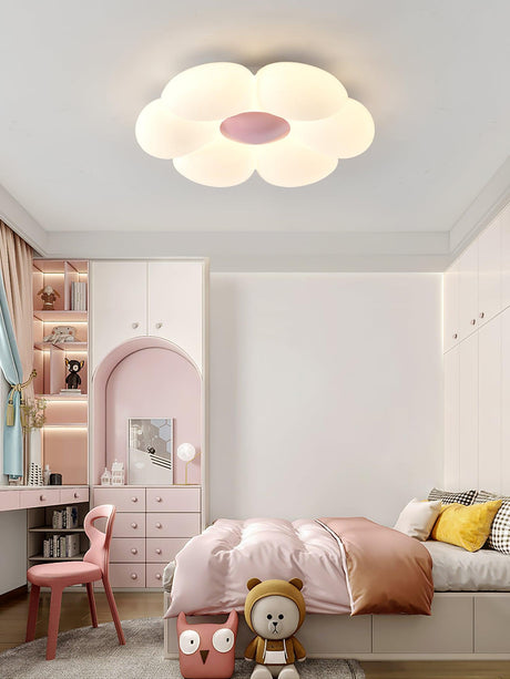 Flower ceiling light with a pink center in a bedroom with a pink arch