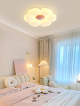 Flower ceiling light with a pink center in a bedroom with a pink rug
