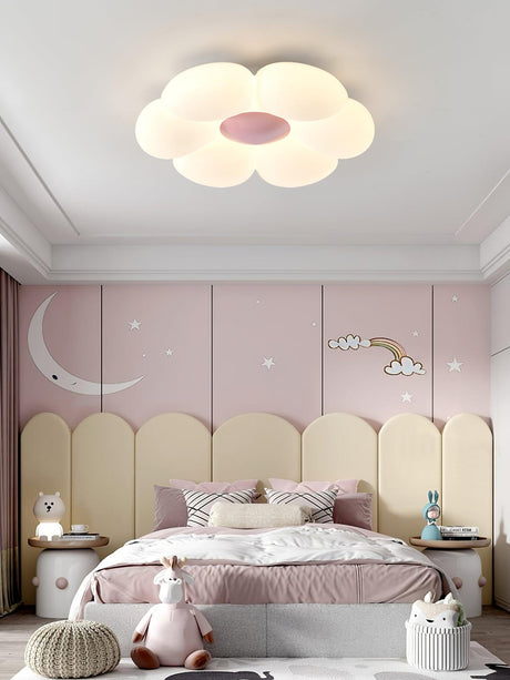 Flower ceiling light with a pink center in a bedroom with moon wall decor