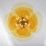 The amber petal shade seen straight from below with the lamps lit inside