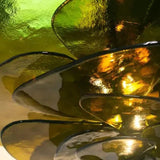 Close view of the tinted glass petals overlapping at their edges