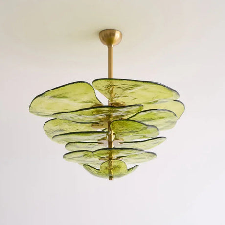 The green petal shade lit from below showing the stacked glass leaves