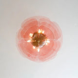 The pink petal shade seen straight from below with the lamps lit inside