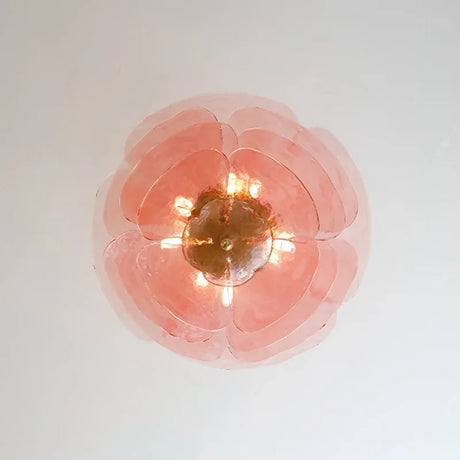 The pink petal shade seen straight from below with the lamps lit inside