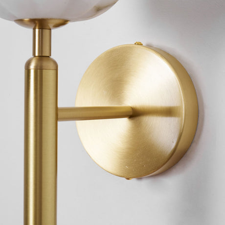 Close view of the brass round plate and the arm holding the shade