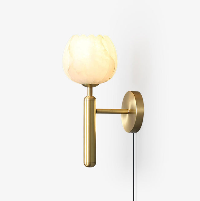 Wall lamp with a carved stone flower shade on a brass arm and round plate