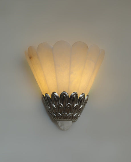 The fan shade lit warm, light rising from the metal petals
