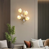 The light above a curved sofa with cushions and a small palm in a gray room