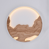 Close view of the layered wood carving and the lit acrylic panel behind it