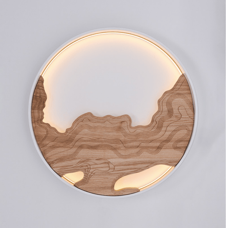 Close view of the layered wood carving and the lit acrylic panel behind it