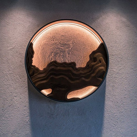 Carved disc lit on a textured plaster wall, the light spilling around it