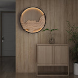 Carved disc lit on a wood paneled wall above a low cabinet and a plant