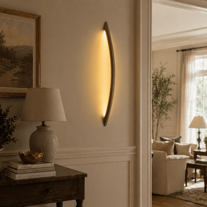 Rod lit vertically on a hallway wall beside a console and a lamp