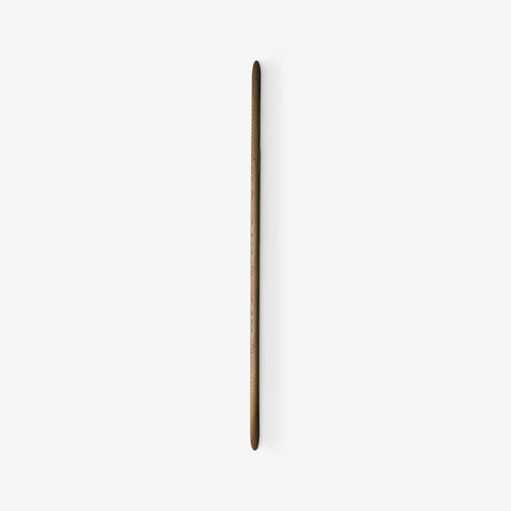 Slim tapered walnut rod mounted flat on a pale wall, seen unlit