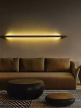 Lit rod above a wide sofa seen from across a plain living room