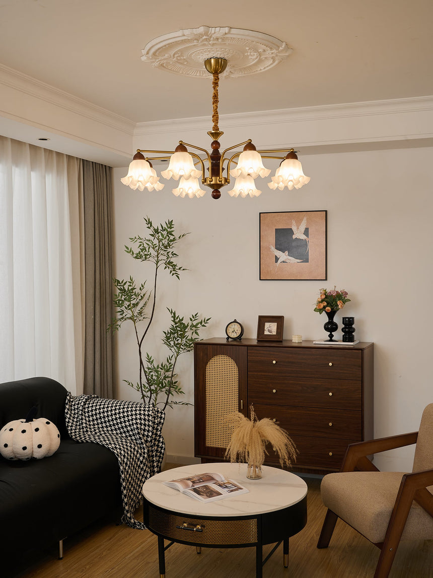 The fitting lit beside a tall window above a table and a chair
