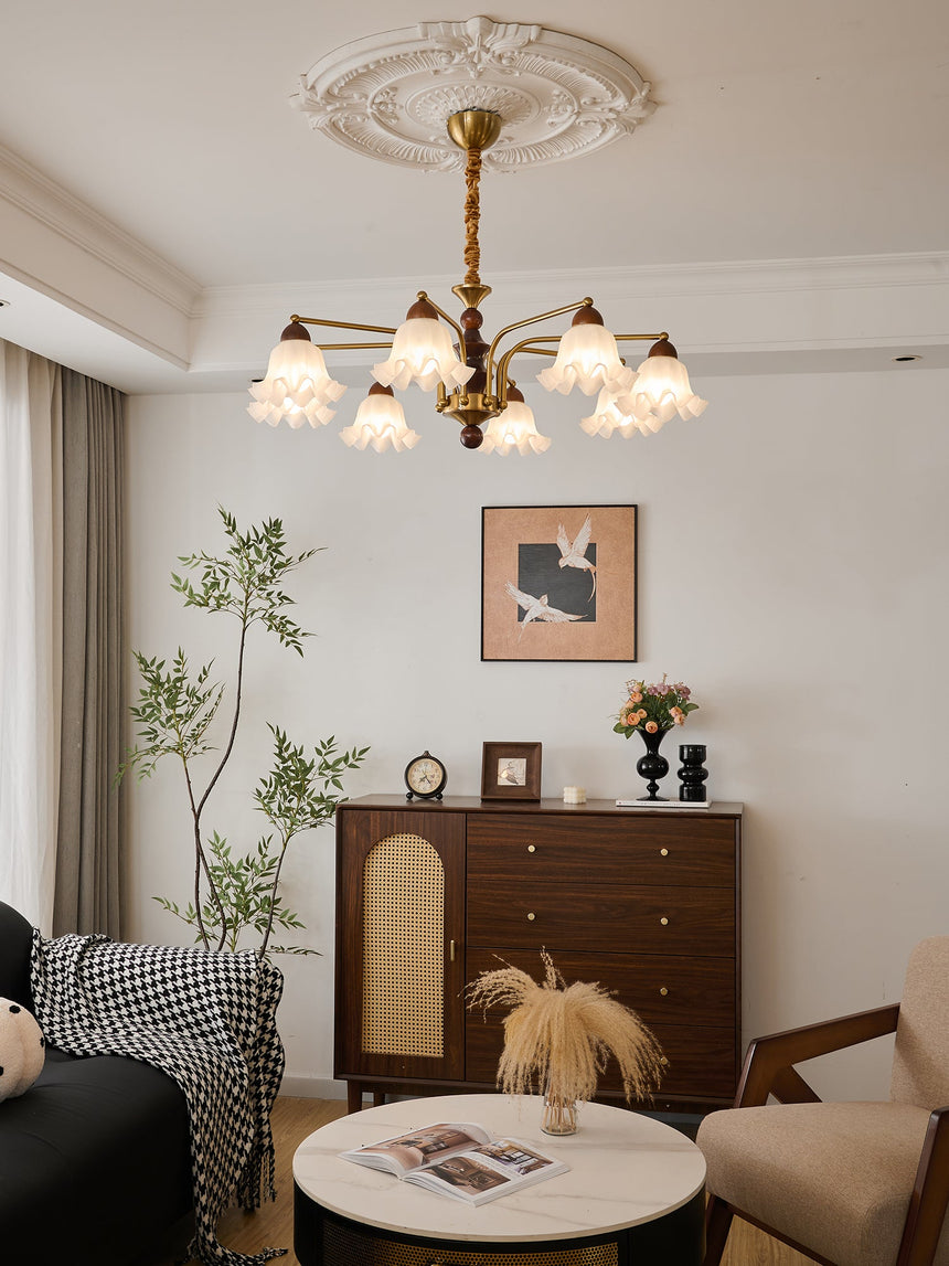 The bells lit in a bedroom corner beside a headboard and a chest