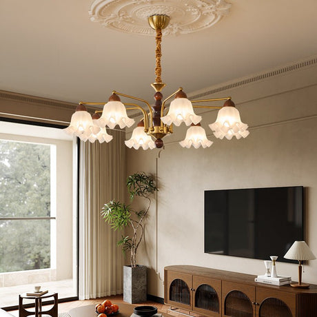 Chandelier lit in a living room above a low table and a wall screen