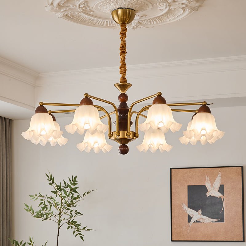 The bells lit above a dark coffee table with a pale sofa around it