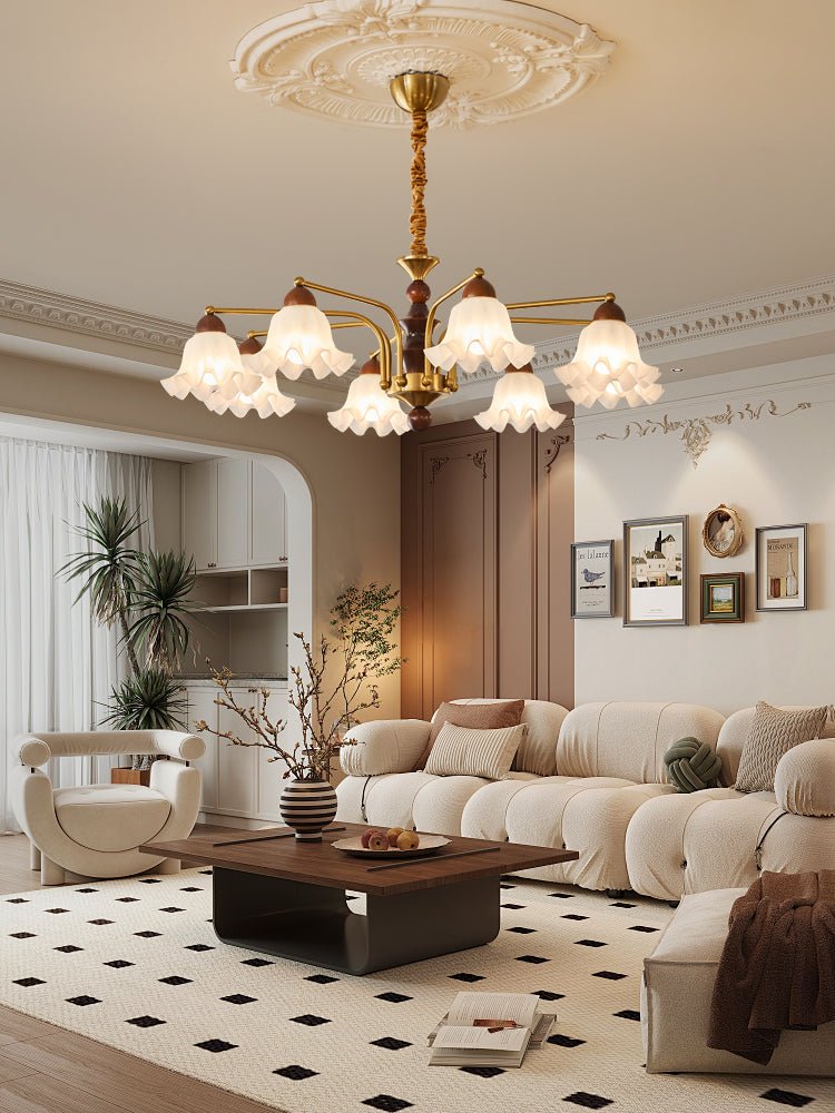 Chandelier lit above a curved sofa on a checkerboard floor