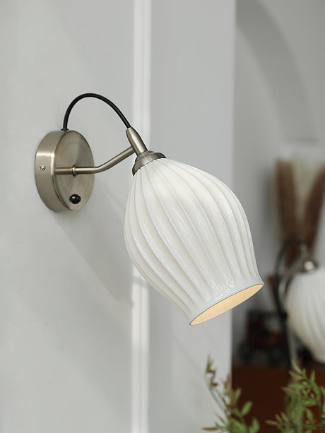 The sconce with the sand nickel plate on a gray wall