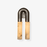 The sconce on a plain background, two ribbed columns under a metal arch