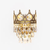 Gold tone crown shaped wall lamp with round crystal medallions and tiers of crystal drops