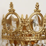 Close view of the gold crown with its round crystal medallions and scrollwork