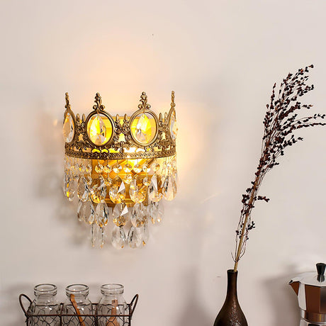 The crown lamp lit above a shelf with glass jars, a vase and dried branches