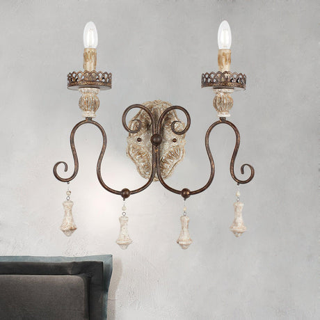Sconce mounted on a plaster wall above a bed with a gray upholstered frame