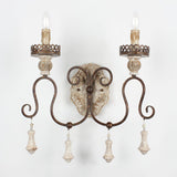 The turned wood drops hanging under each arm below the carved backplate