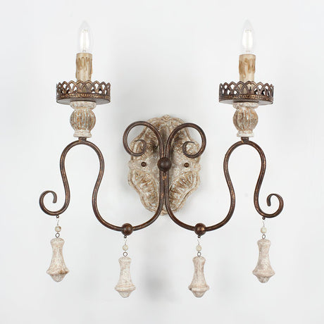 The turned wood drops hanging under each arm below the carved backplate