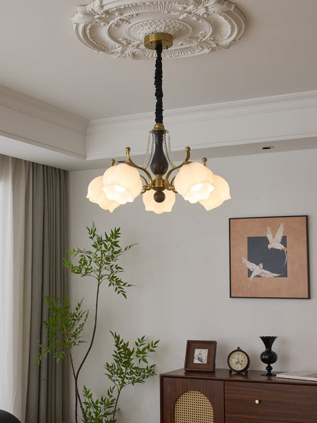 The fitting lit beside a long curtain above a chest and a clock