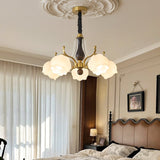 The shades lit in a bedroom corner beside a headboard and a lamp
