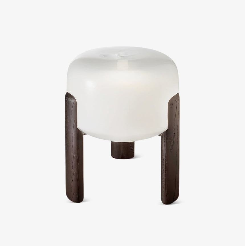 Frosted glass table lamp seen from the front on a plain pale ground
