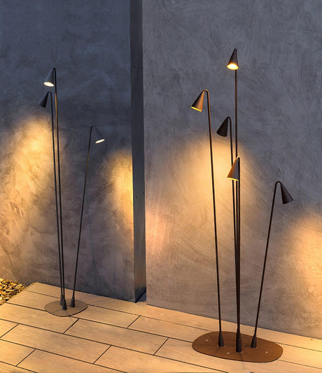 Two clusters lit on paving against a textured render garden wall