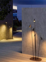 The cluster lit against a pale render wall at the edge of decking