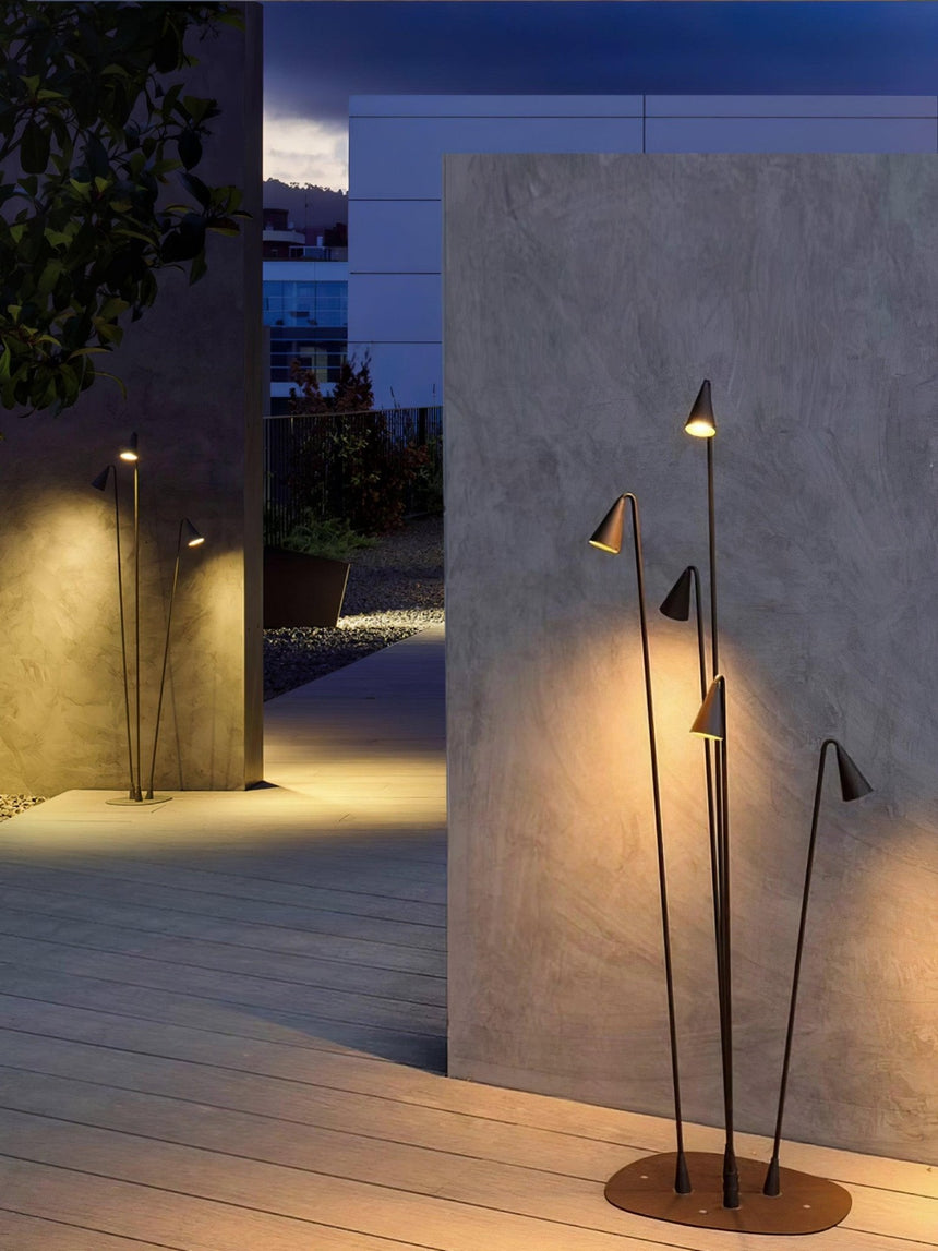 The cluster lit against a pale render wall at the edge of decking