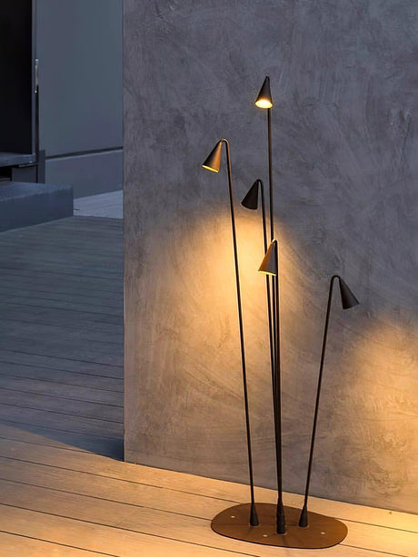 The cluster lit at a terrace corner against a pale render wall