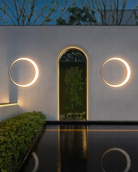 Two rings on either side of an arched doorway above a narrow pool