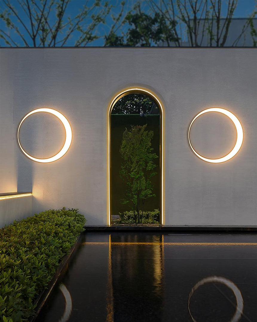 Two rings on either side of an arched doorway above a narrow pool