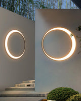 Two rings lit on pale walls beside a short flight of outdoor steps
