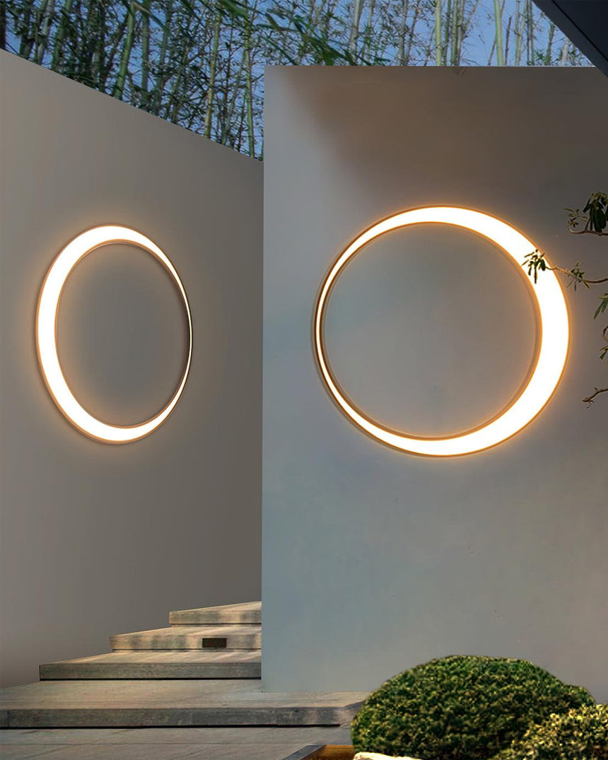Two rings lit on pale walls beside a short flight of outdoor steps