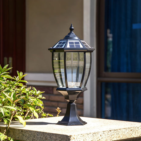 The lantern lit on a pillar with planting and a blue door behind it