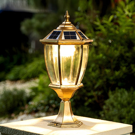 The lantern glowing on a masonry pillar surrounded by garden foliage