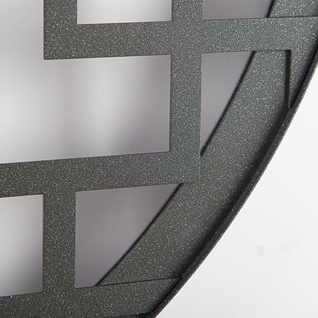 Close view of the textured black steel lattice where it meets the outer ring