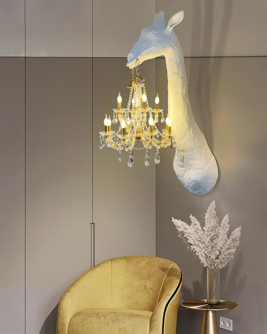 The giraffe lamp above a yellow velvet armchair and a vase of pampas grass